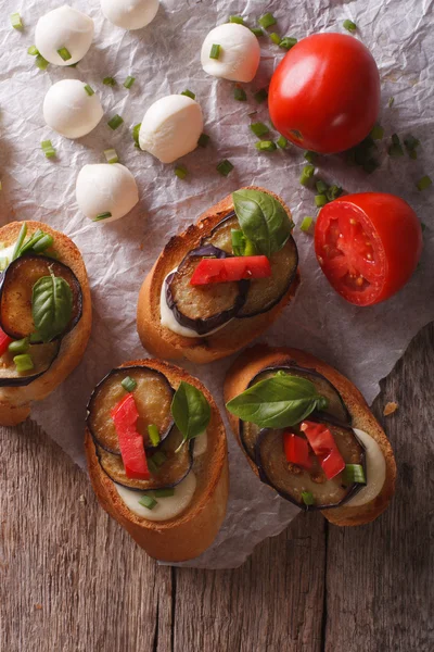 Crostini con berenjena, tomate y queso de cerca. vertical a —  Fotos de Stock