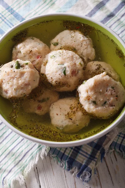 Bread dumplings with broth, close-up  on the table. vertical top — Stock Photo, Image