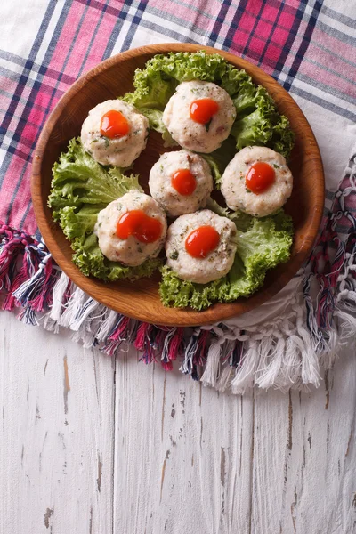 Stock image canederli with tomato sauce on a plate. Vertical top view