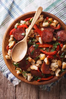 migas with chorizo, bread crumbs and vegetables closeup. vertica