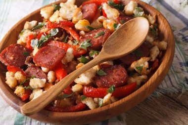 Spanish migas with chorizo, bread crumbs and vegetables close-up clipart