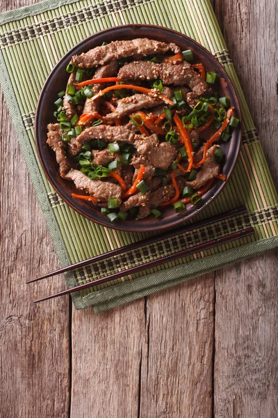 Asian Bulgogi beef slices fried with sesame on a plate. vertical — Stockfoto