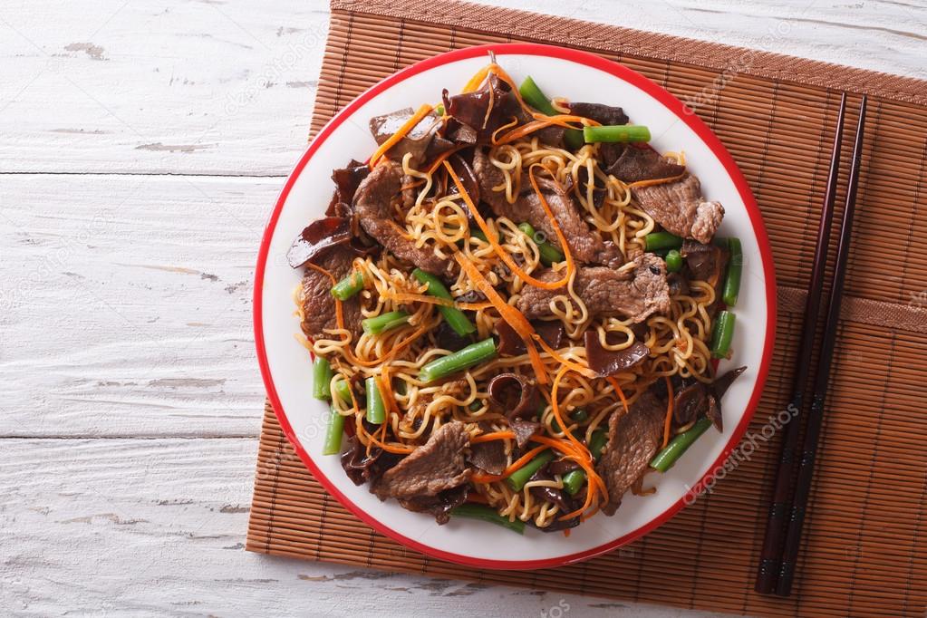 Chinese noodles with beef, muer and vegetables. Horizontal top v