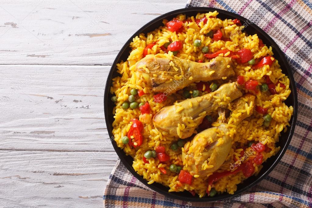 Spanish paella with chicken and vegetables. horizontal top view