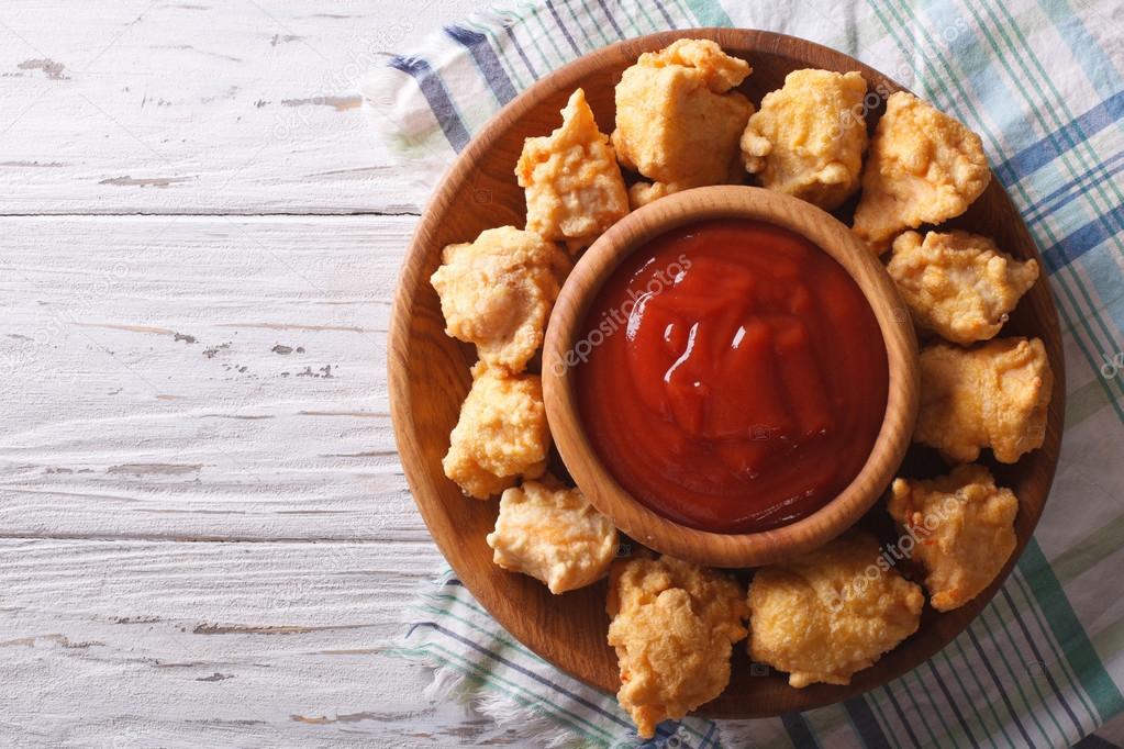crispy popcorn chicken with barbecue sauce horizontal top view