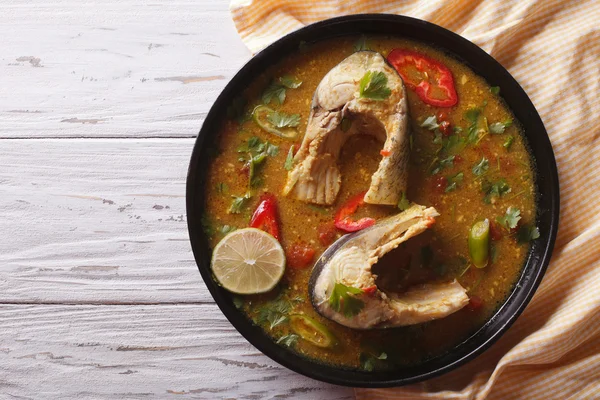 Spicy fish curry with cilantro on the table. horizontal top view — Stock Image Spicy fish curry with cilantro on the table. horizontal top view Royalty Free Stock Photos