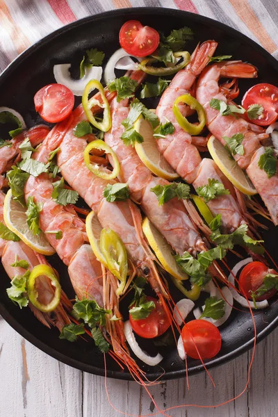 Prawns with herbs and vegetables close-up in a pan. vertical top — Stock Photo, Image