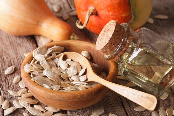 Pumpkin seed oil in a glass jar on the table close-up. Horizonta — Stock Photo, Image