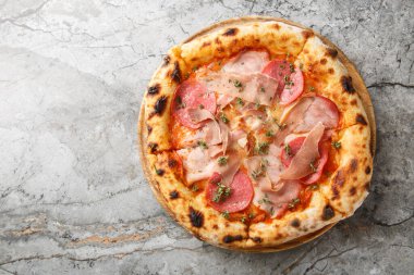 Prosciutto, salam, pastırma ve jambonlu nefis otantik et pizzası masanın üzerinde tahtaya yakın plan. Yukarıdan yatay üst görünüm