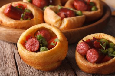 Yorkshire puddings stuffed with sausages close-up. horizontal