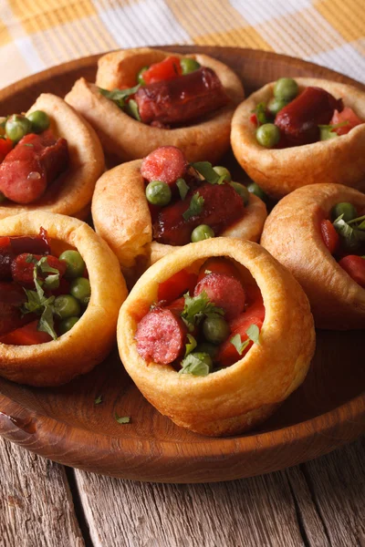 Homemade Yorkshire pudding with sausages close-up. Vertical — 图库照片