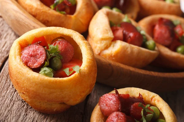 Yorkshire pudding filled with sausages and vegetables closeup. h — ストック写真