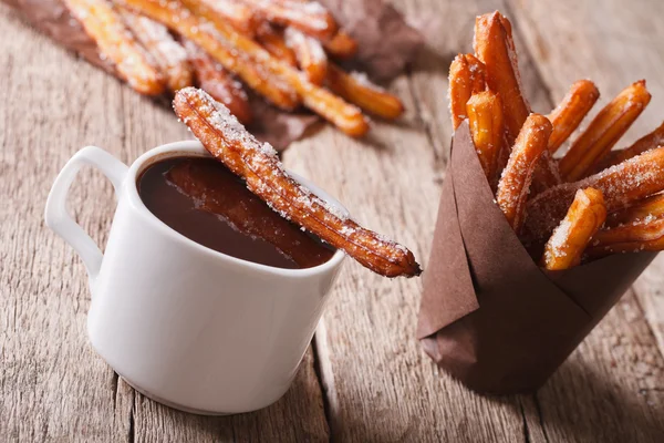 Spanish dessert: churros and hot chocolate close-up. horizontal — Stock Photo, Image