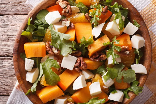 Salad with persimmon, arugula and cheese closeup. horizontal top — ストック写真