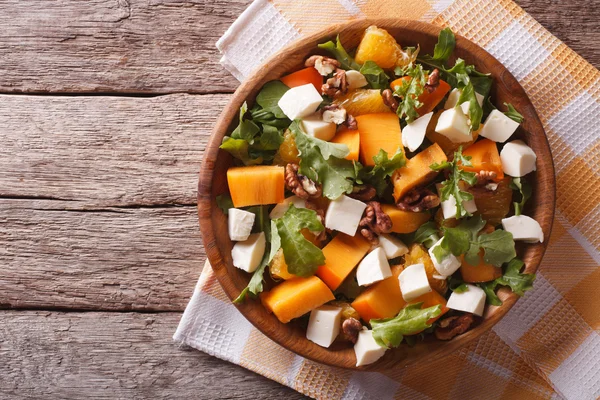 Salad with persimmon, nuts, arugula and cheese. horizontal top v — ストック写真