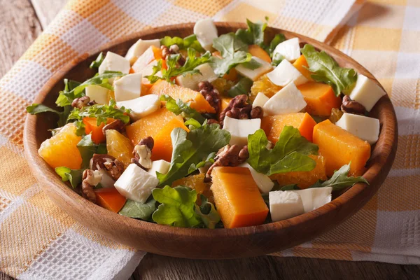 Salad with persimmon, arugula, oranges and cheese. Horizontal, r — ストック写真