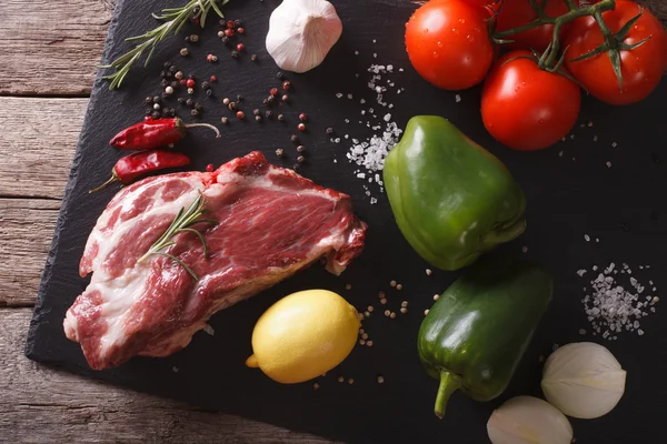 Pork neck raw and ingredients closeup on a slate. horizontal top — Stock Photo, Image