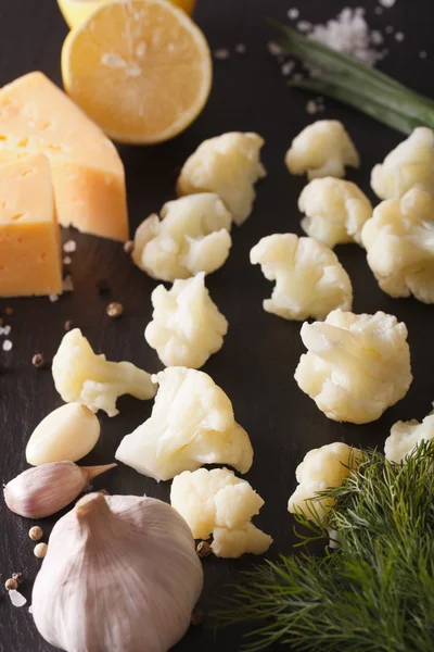 Cauliflower with ingredients macro on a slate board. vertical — Stock Photo, Image