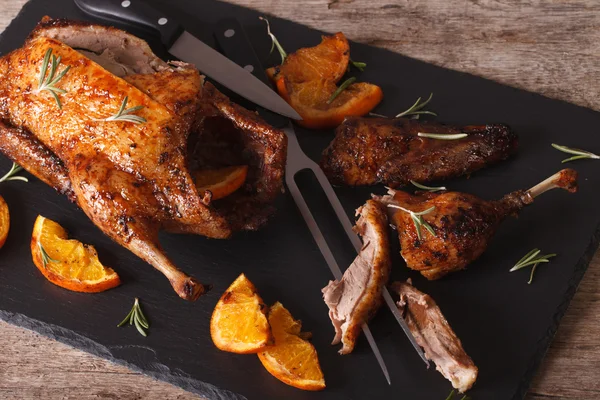 Sliced roast duck and closeup on a black slate board. Horizontal