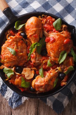 Cacciatori Chicken with mushrooms closeup in a pan. vertical top