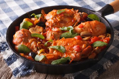 Chicken with tomatoes and vegetables closeup in a pan. horizonta
