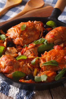 Italian food: chicken with tomato and vegetables. Vertical
