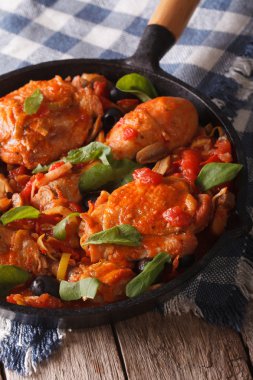 Homemade Cacciatori chicken with mushrooms in a pan vertical