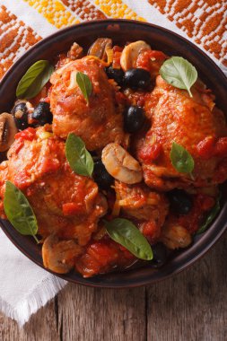 Homemade Cacciatori chicken on a plate close-up. vertical top vi