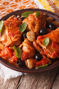 Italian cuisine: Cacciatori chicken with mushrooms closeup. Vert