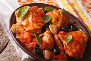 Cacciatori chicken with mushrooms on a plate close-up. horizonta