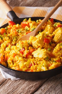 Hispanic rice with chicken and vegetables close-up in a pan. ver