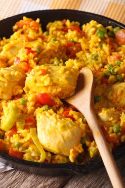 Rice with chicken and vegetables macro in a frying pan. Vertical