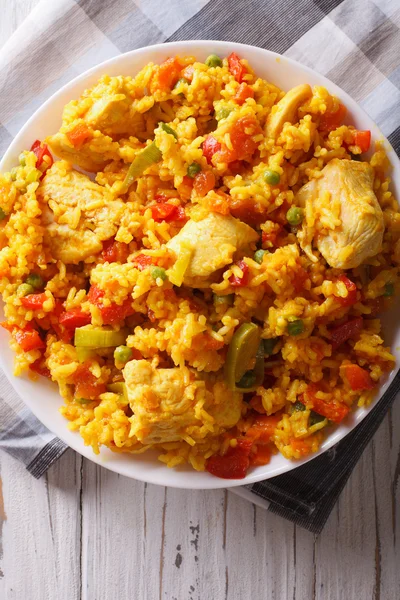 Rice with chicken and vegetables close up in a bowl. vertical to