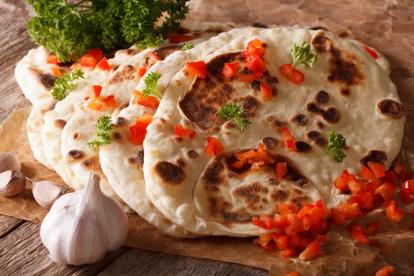 Indian Naan flat bread with garlic and pepper macro. horizontal — Stock Photo, Image