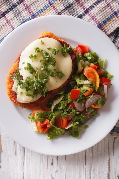 Italian chicken Parmigiana and salad close up. Vertical top view — Stock Photo, Image