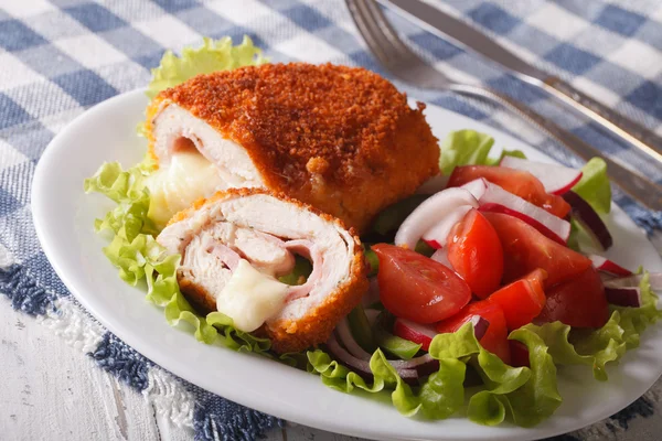 Sliced Chicken cordon bleu schnitzel and salad closeup. horizont — Stock Photo, Image