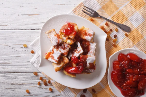 Kaiserschmarrn with plum sauce on a plate. Horizontal top view — Stock Photo, Image