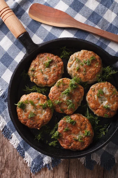 Fish cakes with herbs in a pan. vertical top view — Stock Photo, Image