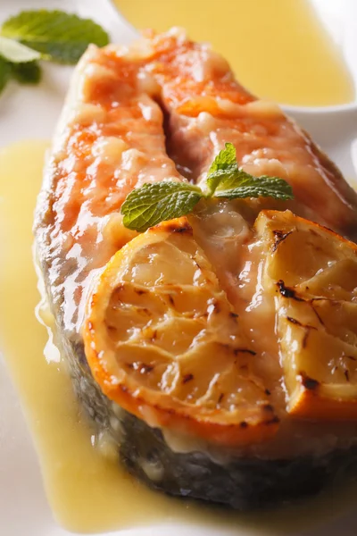 Baked salmon steak in orange sauce macro. vertical — Stock Photo, Image