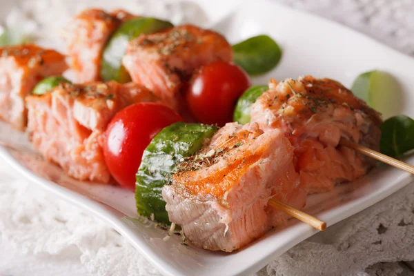 Grilled salmon on skewers macro on a plate. Horizontal — Stock Photo, Image