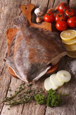 raw flounder with ingredients on a cutting board close-up. verti clipart