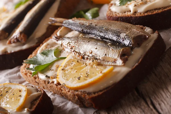 Fish Sandwiches with sprats and cream cheese close-up. Horizonta — Stock Photo, Image