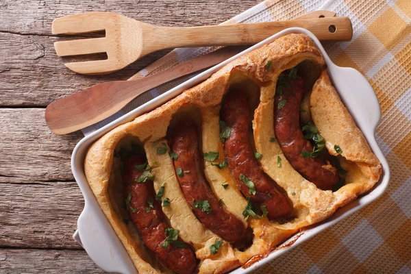 Sausage baked in pastry in a dish close up. Horizontal top view — Stock Photo, Image
