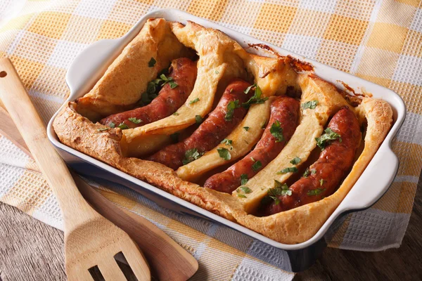 English food: toad in the hole into a baking dish close up. Hori — Stock Photo, Image