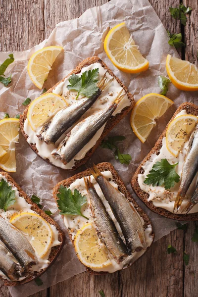 Sandwiches with sprats, cream cheese close-up. vertical top view — Stock Image Sandwiches with sprats, cream cheese close-up. vertical top view Royalty Free Stock Photos