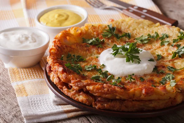 Rosti with sauce and parsley closeup on a plate. Horizontal — Stock Photo, Image