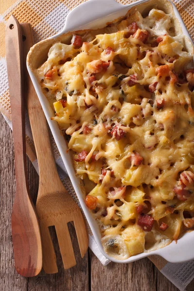 Tartiflette potatoes with bacon and cheese close up vertical top — Stock Photo, Image