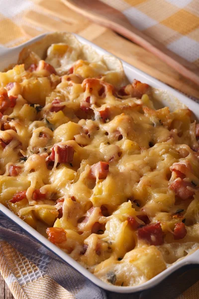 Potato with bacon and cheese close up in baking dish. Vertical — Stock Photo, Image