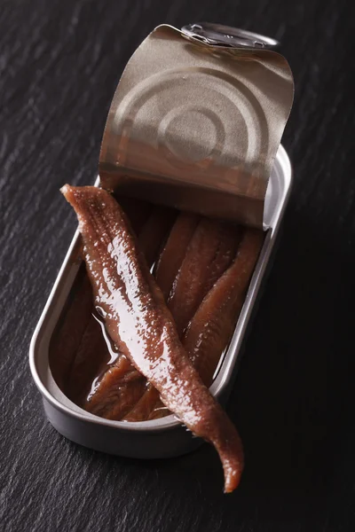 stock image Canned anchovy fillets closeup on a slate board. vertical