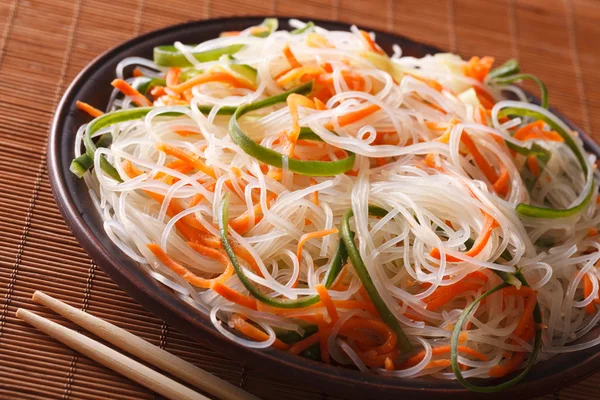 Crystal noodles with cucumber and carrot on a plate close-up. Ho — Stock Photo, Image